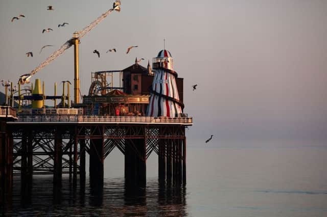 Two thrill-seekers somersaulting from the top of a helter skelter at the end of a pier (Credit: Sam Shaw/SWNS.com)